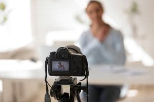 Businesswoman recording video blog on professional digital equipment