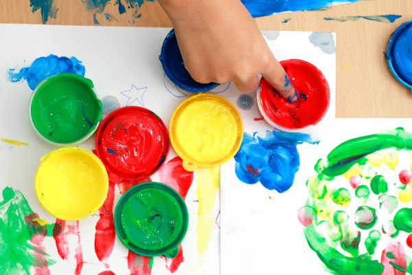 Children,Finger,And,Paints,On,A,Table.,Children,Playing,The