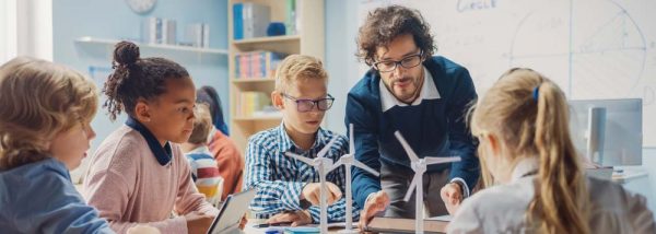 Elementary,School,Classroom:,Enthusiastic,Teacher,Holding,Tablet,Computer,Explains,To